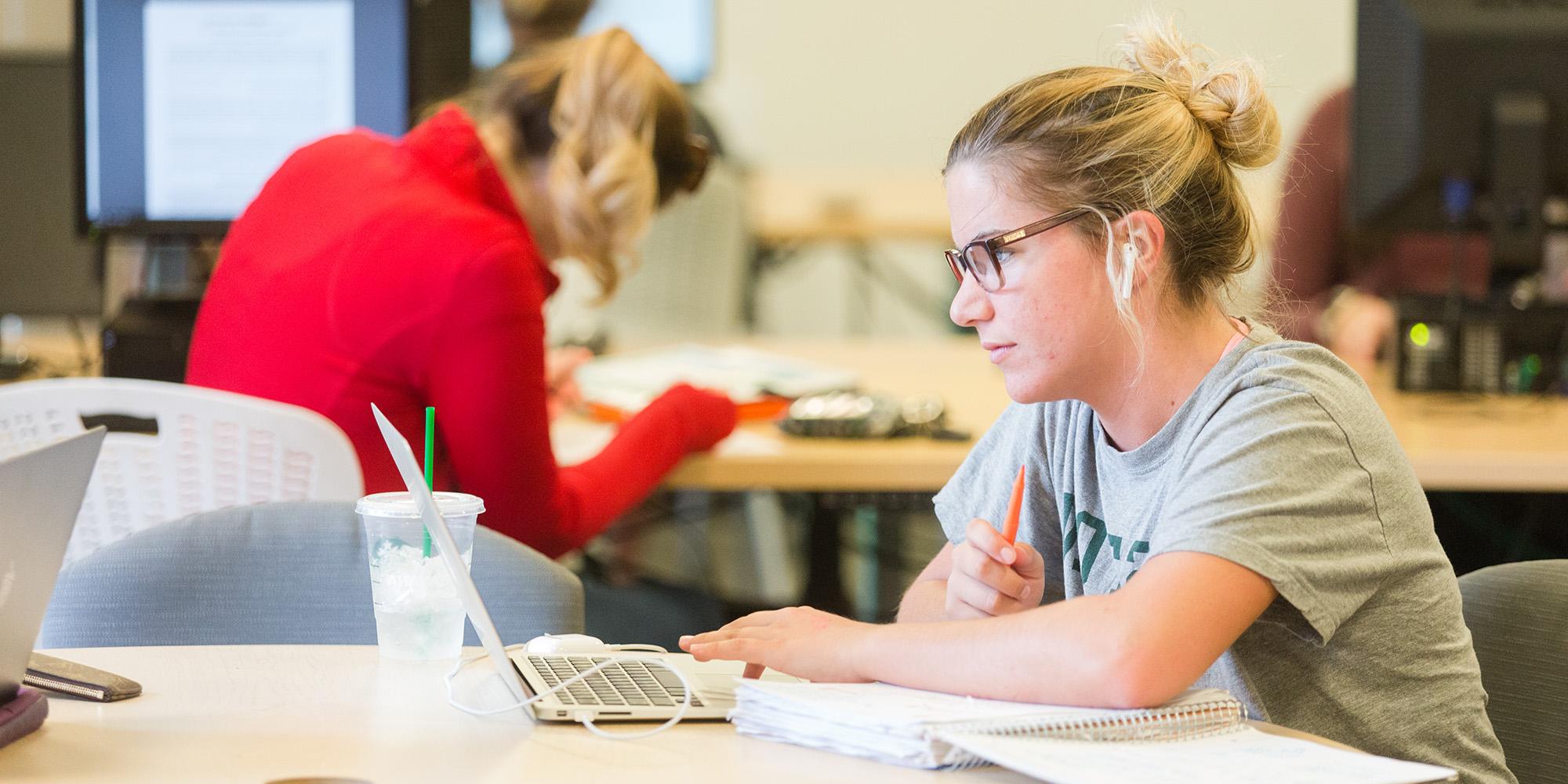 Female Student Studying With Laptop